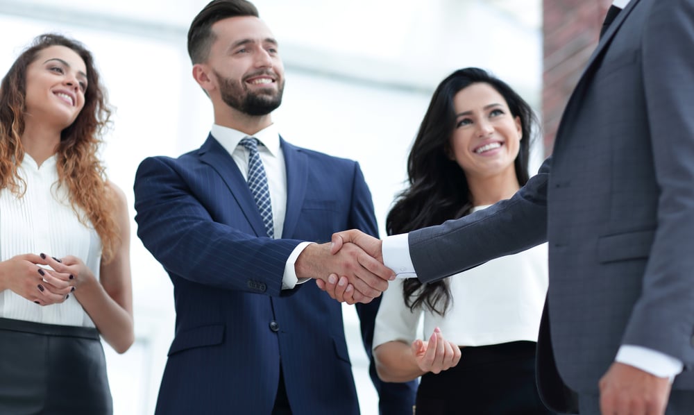 Busines-men-and-women-smiling-and-shaking-hands-humans-helping-humans
